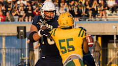 UBC offensive tackle Giovanni Manu blocks.