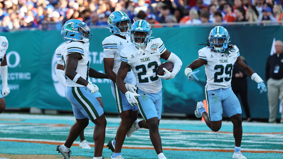 Dec 20, 2024; Tampa, FL, USA; Tulane Green Wave safety Kevin Adams III (23) celebrates after intercepting the ball against the Florida Gators during the first quarter at Raymond James Stadium. 