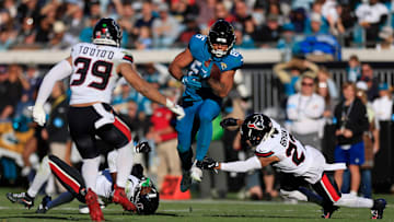 Houston Texans cornerback Kamari Lassiter (4) looks at a leaping Jacksonville Jaguars tight end Brenton Strange (85) as Houston Texans cornerback Myles Bryant (27) can’t make the stop and linebacker Henry To'oTo'o (39) looks on during the third quarter of an NFL football matchup Sunday, Dec. 1, 2024 at EverBank Stadium in Jacksonville, Fla. 