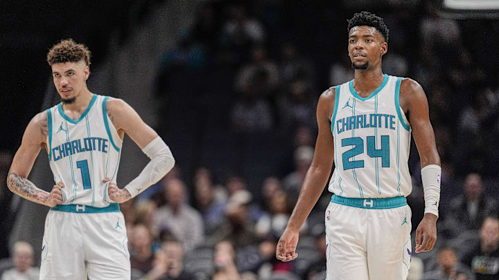 Oct 8, 2024; Charlotte, North Carolina, USA; Charlotte Hornets guard LaMelo Ball (1) and forward Brandon Miller (24) at mid court against the Miami Heat during the second half at Spectrum Center. Mandatory Credit: Jim Dedmon-Imagn Images