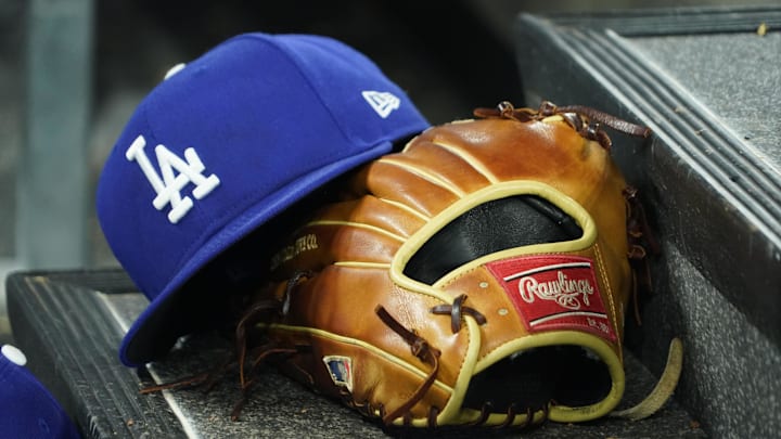 Apr 28, 2024; Toronto, Ontario, CAN; A hat and glove of an Los Angeles Dodgers player durng a game against the Toronto Blue Jays at Rogers Centre. Mandatory Credit: John E. Sokolowski-Imagn Images Apr 28, 2024; Toronto, Ontario, CAN; A hat and glove of an Los Angeles Dodgers player durng a game against the Toronto Blue Jays at Rogers Centre. Mandatory Credit: John E. Sokolowski-Imagn Images