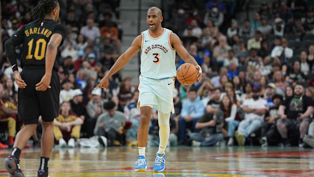 San Antonio Spurs guard Chris Paul (3) dribbles the ball in front of Cleveland Cavaliers guard Darius Garland (10)