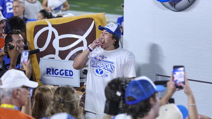 Dec 27, 2025; Orlando, FL, USA; BYU Cougars quarterback Bear Bachmeier (47) eats a Pop-Tart after beating the Georgia Tech Yellow Jackets in the Pop-Tarts Bowl at Camping World Stadium. Mandatory Credit: Nathan Ray Seebeck-Imagn Images