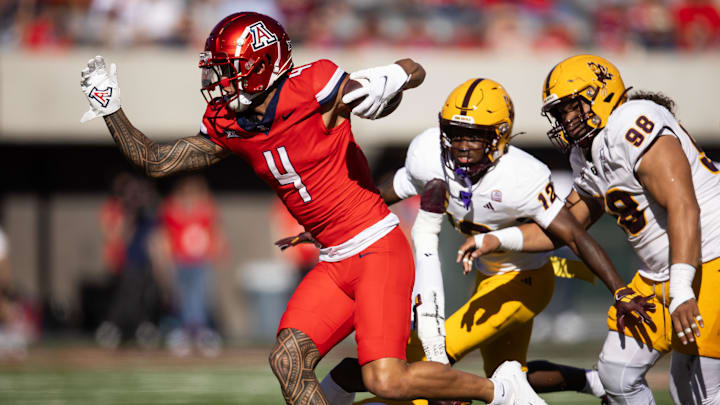 Nov 30, 2024; Tucson, Arizona, USA; Arizona Wildcats wide receiver Tetairoa McMillan (4) against the Arizona State Sun Devils in the first half during the Territorial Cup at Arizona Stadium. Mandatory Credit: Mark J. Rebilas-Imagn Images