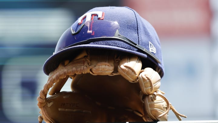 May 29, 2023; Detroit, Michigan, USA;  Texas Rangers cap and glove in the dugout in the first inning against the Detroit Tigers at Comerica Park. Mandatory Credit: Rick Osentoski-USA TODAY Sports