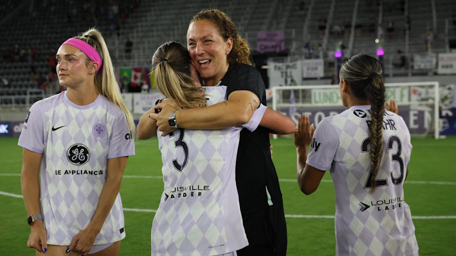 Racing Louisville assistant coach Carmelina Moscato (third from left) embraces the players at Lynn Family Stadium.