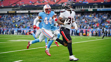 Houston Texans running back Dameon Pierce (31) runs in a touchdown past Tennessee Titans safety Mike Brown (44) during the second quarter at Nissan Stadium in Nashville, Tenn., Sunday, Jan. 5, 2025.
