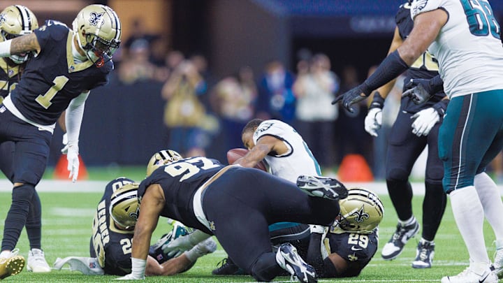 Sep 22, 2024; New Orleans, Louisiana, USA; Philadelphia Eagles wide receiver DeVonta Smith (6) is injured on a tackle by New Orleans Saints defensive tackle Khristian Boyd (97) during the second half at Caesars Superdome. Mandatory Credit: Stephen Lew-Imagn Images