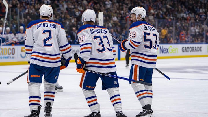 Edmonton Oilers defenseman Evan Bouchard (2) and forward Viktor Arvidsson (33) and forward Jeff Skinner (53)