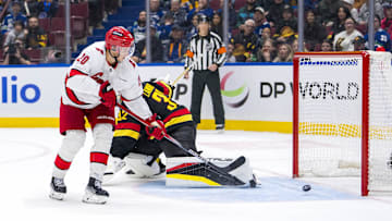 Oct 28, 2024; Vancouver, British Columbia, CAN; Carolina Hurricanes forward Sebastian Aho (20) scores the game winning goal on Vancouver Canucks goalie Kevin Lankinen (32) in overtime at Rogers Arena. Mandatory Credit: Bob Frid-Imagn Images