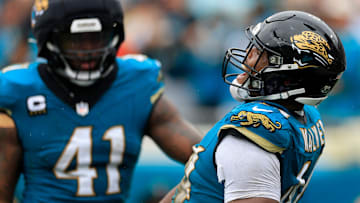 Jacksonville Jaguars defensive end Travon Walker (44) reacts to forcing a fumble with defensive end Josh Hines-Allen (41) during the second quarter of an NFL football matchup Sunday, Oct. 6, 2024 at EverBank Stadium in Jacksonville, Fla.