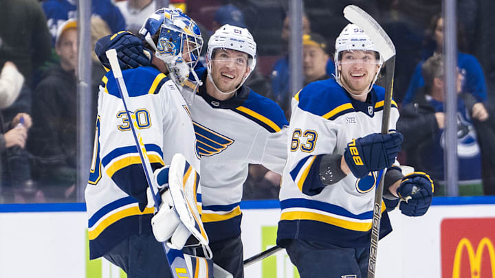 Dec 10, 2024; Vancouver, British Columbia, CAN; St. Louis Blues goalie Joel Hofer (30) and forwards Dylan Holloway (81) and Jake Neighbours (63) celebrate Holloway’s game winning goal against the Vancouver Canucks during overtime at Rogers Arena. Mandatory Credit: Bob Frid-Imagn Images
