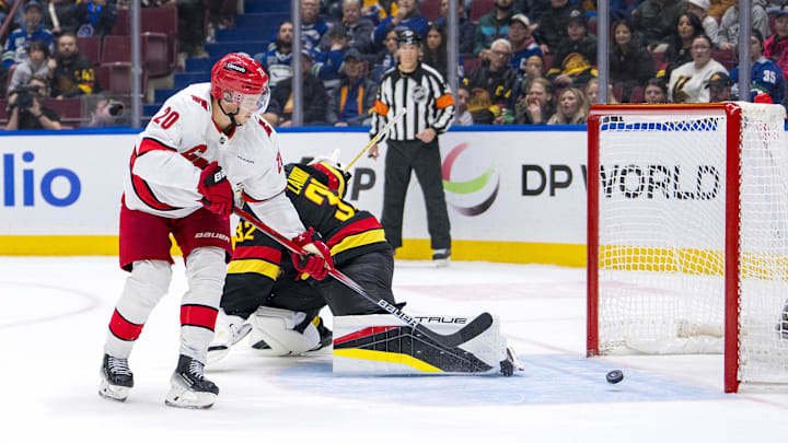 Oct 28, 2024; Vancouver, British Columbia, CAN; Carolina Hurricanes forward Sebastian Aho (20) scores the game winning goal on Vancouver Canucks goalie Kevin Lankinen (32) in overtime at Rogers Arena. Mandatory Credit: Bob Frid-Imagn Images