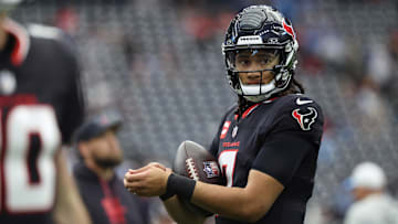 Jan 11, 2025; Houston, Texas, USA; Houston Texans quarterback C.J. Stroud (7) warms up prior to the game against the Los Angeles Chargers in an AFC wild card game at NRG Stadium.