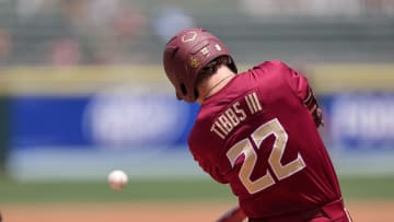 May 25, 2024; Charlotte, NC, USA; Florida State outfielder James Tibbs III (22) hits a ball in the second inning against Wake Forest during the ACC Baseball Tournament at Truist Field. Mandatory Credit: Cory Knowlton-USA TODAY Sports
