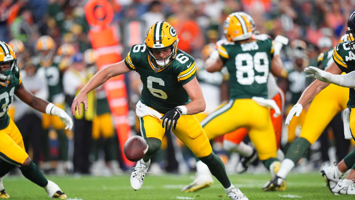 Green Bay Packers quarterback Sean Clifford (10) chases down a fumbled football to start Sunday's game at the Denver Broncos.