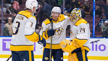 Nov 17, 2024; Vancouver, British Columbia, CAN; Nashville Predators defenseman Jeremy Lauzon (3) and forward Gustav Nyquist (14) and goalie Juuse Saros (74) celebrate the victory against the Vancouver Canucks at Rogers Arena. Mandatory Credit: Bob Frid-Imagn Images