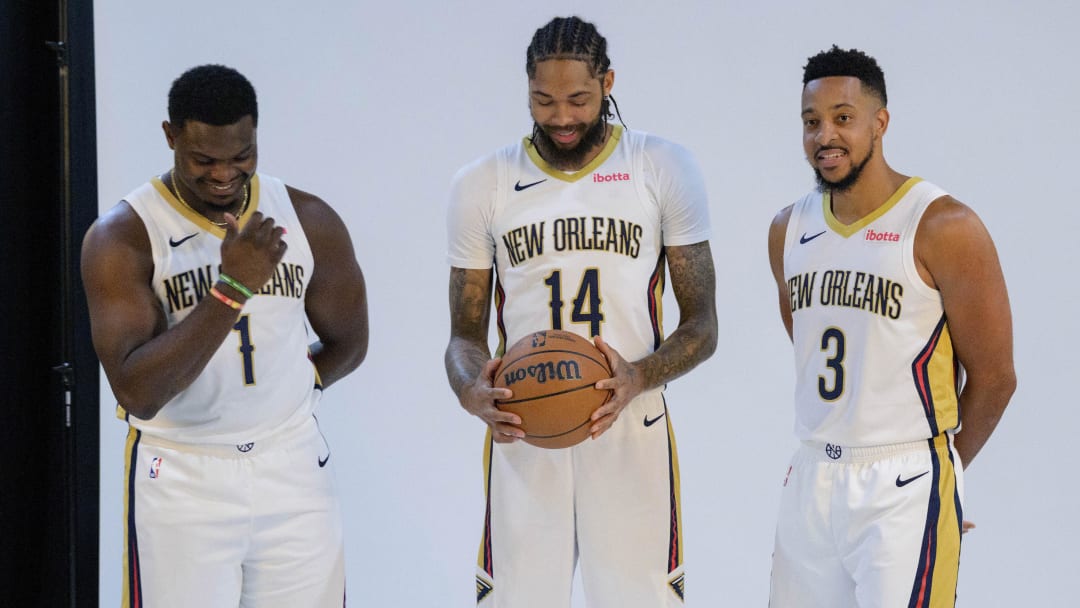 Oct 2, 2023; New Orleans, LA, USA; New Orleans Pelicans forward Zion Williamson (1), forward Brandon Ingram (14), and guard CJ McCollum (3) giggle as they pose during Pelicans media day at the Smoothie King Center.