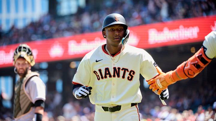 May 19, 2024; San Francisco, California, USA; San Francisco Giants infielder Marco Luciano (37) shakes hands with a teammate after scoring a run against the Colorado Rockies during the fifth inning at Oracle Park. Mandatory Credit: Robert Edwards-Imagn Images