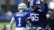 New York Giants wide receiver Malik Nabers celebrates with offensive tackle James Hudson III during training camp