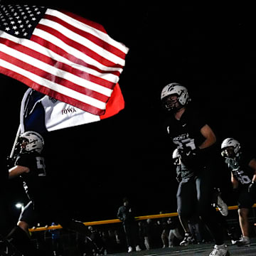 The Iowa City Liberty Lightning take the field Nov. 7, 2025 before an Iowa high school quarterfinal football game against Southeast Polk in North Liberty, Iowa.