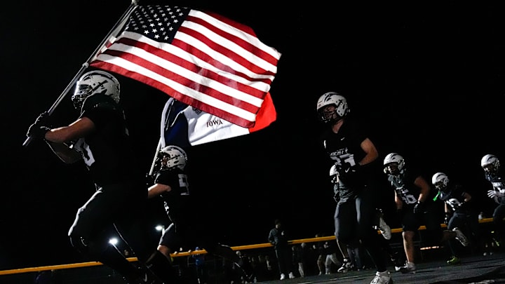 The Iowa City Liberty Lightning take the field Nov. 7, 2025 before an Iowa high school quarterfinal football game against Southeast Polk in North Liberty, Iowa.