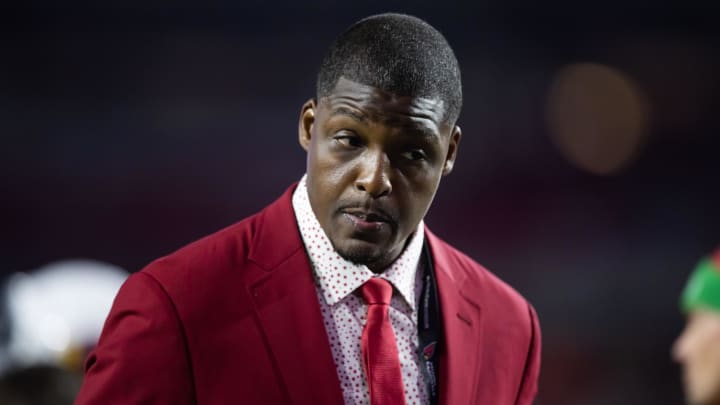 Cardinals director of pro scouting Adrian Wilson stands on the field before a game in 2022.