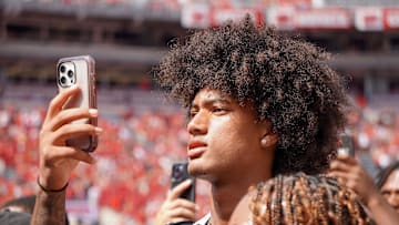Aug 31, 2024; Columbus, OH, USA; Mater Dei wide receiver Chris Henry Jr. films as Ohio State football warms up before the Buckeyes' 52-6 win over Akron.
