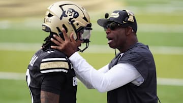 Aug 29, 2025; Boulder, Colorado, USA; Colorado Buffaloes head coach Deion Sanders congratulates Colorado Buffaloes quarterback Kaidon Salter (3) following a touchdown pass in the first quarter against the Georgia Tech Yellow Jackets at Folsom Field. Mandatory Credit: Ron Chenoy-Imagn Images