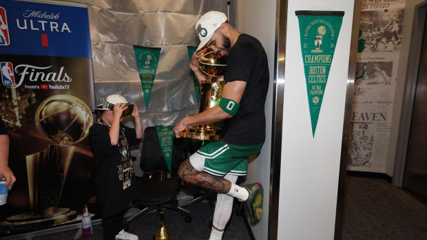 Tatum holds the Larry O’Brien Trophy while celebrating the Celtics’ 2024 NBA championship. 