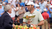 Sep 1, 2024; Atlanta, Georgia, USA; Sep 1, 2024; Atlanta, Georgia, USA; PGA TOUR Commissioner Jay Monahan presents Scottie Scheffler the FedEx Cup after winning the TOUR Championship golf tournament. Mandatory Credit: John David Mercer-Imagn Images