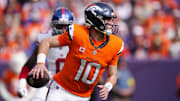 Oct 19, 2025; Denver, Colorado, USA; Denver Broncos quarterback Bo Nix (10) runs the ball during the first half against the New York Giants at Empower Field at Mile High. Mandatory Credit: Ron Chenoy-Imagn Images
