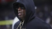 Dec 28, 2024; San Antonio, TX, USA; Colorado Buffaloes head coach Deion Sanders jogs on the field before the game against the Brigham Young Cougars at Alamodome. Mandatory Credit: Troy Taormina-Imagn Images