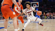 Mar 14, 2025; Charlotte, NC, USA; Louisville Cardinals guard Chucky Hepburn (24) handles the ball against Clemson Tigers guard Jake Heidbreder (3) during the second half at Spectrum Center. Mandatory Credit: Jim Dedmon-Imagn Images