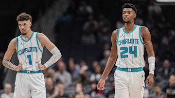Oct 8, 2024; Charlotte, North Carolina, USA; Charlotte Hornets guard LaMelo Ball (1) and forward Brandon Miller (24) at mid court against the Miami Heat during the second half at Spectrum Center. Mandatory Credit: Jim Dedmon-Imagn Images