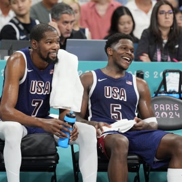 Aug 3, 2024; Villeneuve-d'Ascq, France; United States guard LeBron James (6), guard Kevin Durant (7) and guard Anthony Edwards (5) on the bench in the fourth quarter against Puerto Rico during the Paris 2024 Olympic Summer Games at Stade Pierre-Mauroy. Mandatory Credit: John David Mercer-USA TODAY Sports