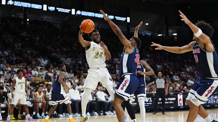 Mar 7, 2026; Boulder, Colorado, USA; Colorado Buffaloes guard Barrington Hargress (24) passes the ball at Arizona Wildcats forward Tobe Awaka (30) in the second half at the CU Events Center. Mandatory Credit: Ron Chenoy-Imagn Images