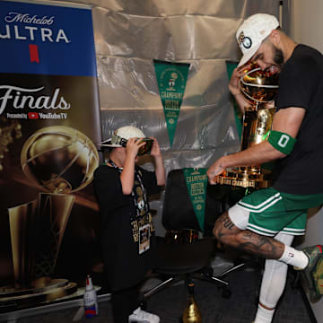 Jun 17, 2024; Boston, Massachusetts, USA; Boston Celtics forward Jayson Tatum (0) holds the Larry O’Brien Championship Trophy after their win against the Dallas Mavericks after game five of the 2024 NBA Finals at TD Garden. Mandatory Credit: Elsa/Pool Photo-Imagn Images