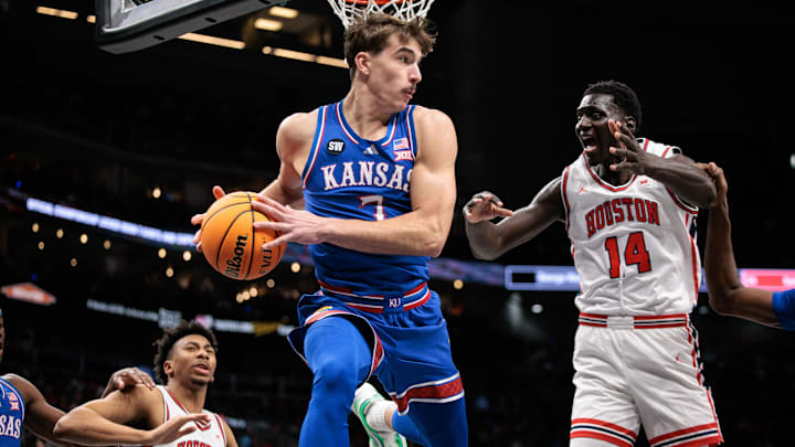 Mar 13, 2026; Kansas City, MO, USA; Kansas Jayhawks guard Kohl Rosario (7) rebounds around Houston Cougars forward Kalifa Sakho (14) during the second half at T-Mobile Center. Mandatory Credit: William Purnell-Imagn Images