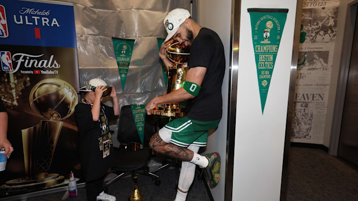 Jun 17, 2024; Boston, Massachusetts, USA; Boston Celtics forward Jayson Tatum (0) holds the Larry O’Brien Championship Trophy after their win against the Dallas Mavericks after game five of the 2024 NBA Finals at TD Garden. Mandatory Credit: Elsa/Pool Photo-Imagn Images