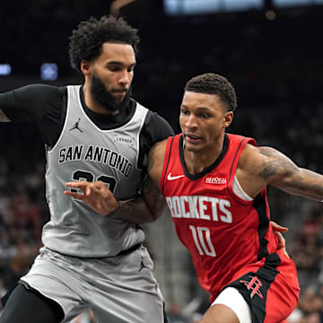 Nov 7, 2025; San Antonio, Texas, USA;  Houston Rockets forward Jabari Smith Jr (10) dribbles against San Antonio Spurs forward Julian Champagnie (30) during the second quarter at Frost Bank Center. Mandatory Credit: Dustin Safranek-Imagn Images