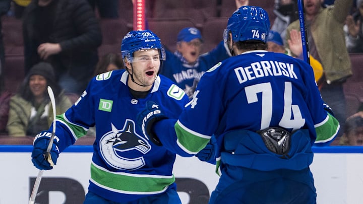 Nov 16, 2024; Vancouver, British Columbia, CAN; Vancouver Canucks defenseman Erik Brannstrom (26) and forward Jake DeBrusk (74) celebrate Brannstrom’s goal against the Chicago Blackhawks during the third period at Rogers Arena. Mandatory Credit: Bob Frid-Imagn Images