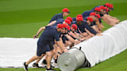 The Cleveland Guardians grounds crew puts the tarp on the field for the second time during a weather delay before a game between the Guardians and the Minnesota Twins at Progressive Field in Cleveland on April 29, 2025.
