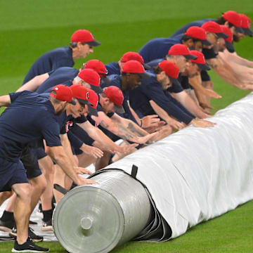 The Cleveland Guardians grounds crew puts the tarp on the field for the second time during a weather delay before a game between the Guardians and the Minnesota Twins at Progressive Field in Cleveland on April 29, 2025.