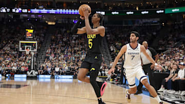 Oct 23, 2024; Salt Lake City, Utah, USA; Utah Jazz forward Cody Williams (5) moves past Memphis Grizzlies forward Santi Aldama (7) and shoots the ball at Delta Center. Mandatory Credit: Chris Nicoll-Imagn Images
