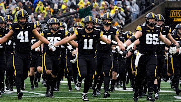 The Iowa Hawkeyes swarm onto the field Nov. 8, 2025, ahead of a Big Ten Football game against the Oregon Ducks at Kinnick Stadium in Iowa City, Iowa.