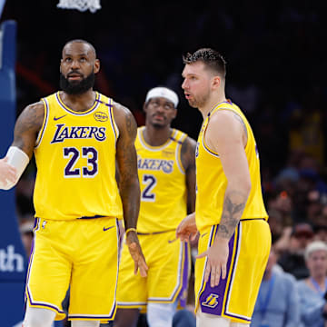 Apr 8, 2025; Oklahoma City, Oklahoma, USA; Los Angeles Lakers forward LeBron James (23) and guard Austin Reaves (15) high five after a play against the Oklahoma City Thunder during the second half at Paycom Center. Mandatory Credit: Alonzo Adams-Imagn Images