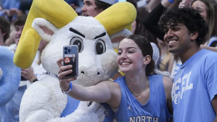 Mar 5, 2024; Chapel Hill, North Carolina, USA; North Carolina Tar Heels mascot Ramses poses for a selfie with students during the first half against the Notre Dame Fighting Irish at Dean E. Smith Center. Mandatory Credit: Jim Dedmon-USA TODAY Sports