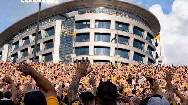 Fans at an Iowa football game wave to the fans during a 2025 contes