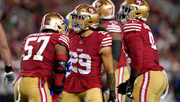 Dec 12, 2024; Santa Clara, California, USA; San Francisco 49ers linebacker Dre Greenlaw (57) is congratulated by safety Talanoa Hufanga (29) after making a tackle against the Los Angeles Rams in the first quarter at Levi's Stadium. Mandatory Credit: Cary Edmondson-Imagn Images
